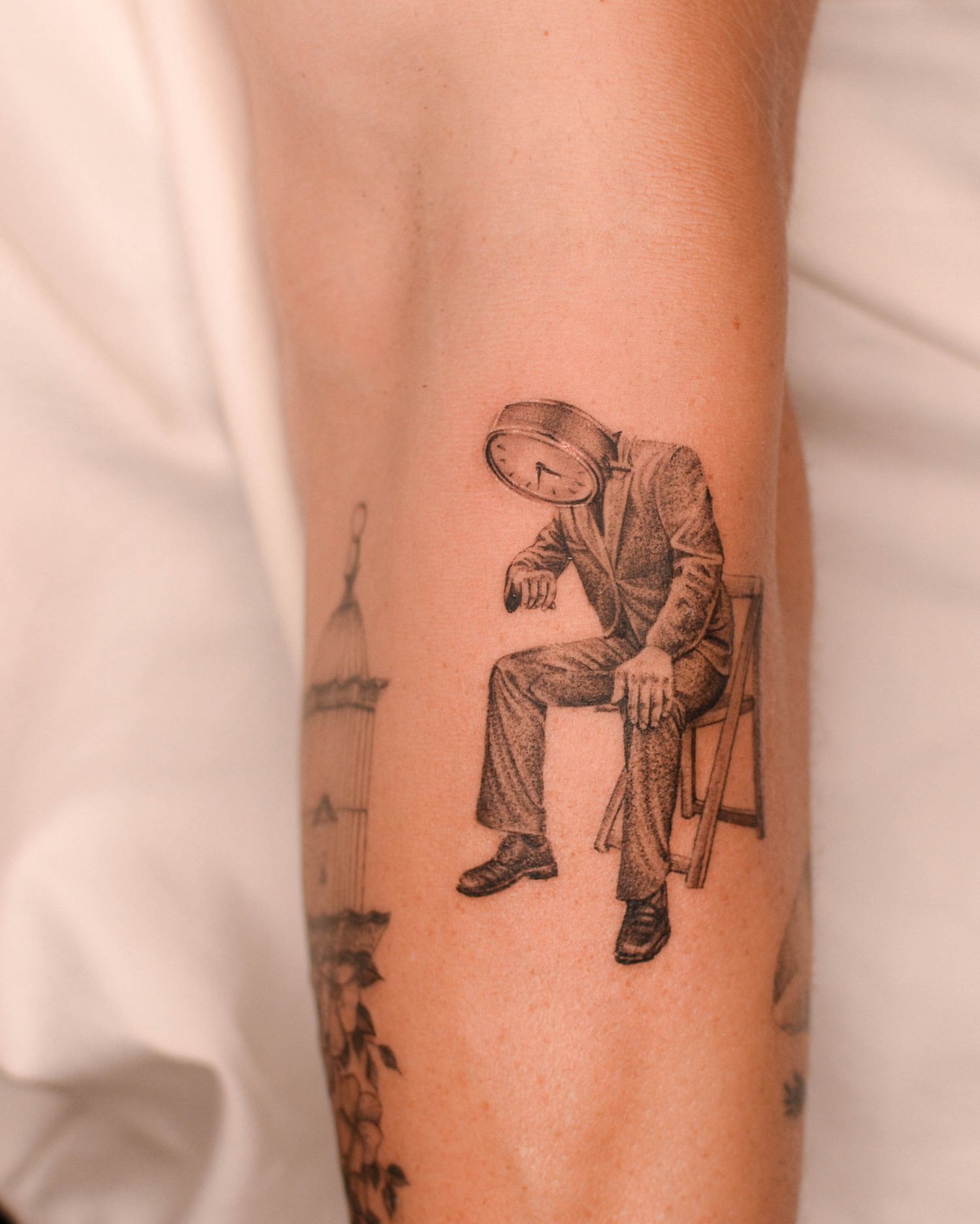 Tattoo — seated figure with a clock face