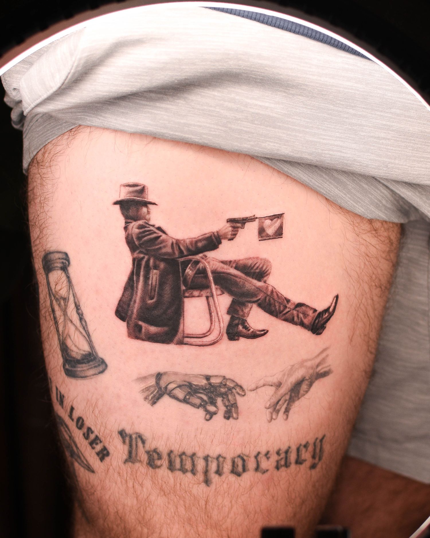 Tattoo — seated figure shooting, thigh