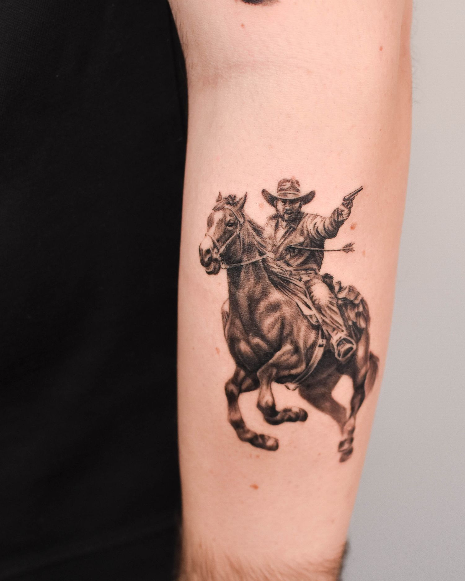 Tattoo — rider at full gallop, forearm