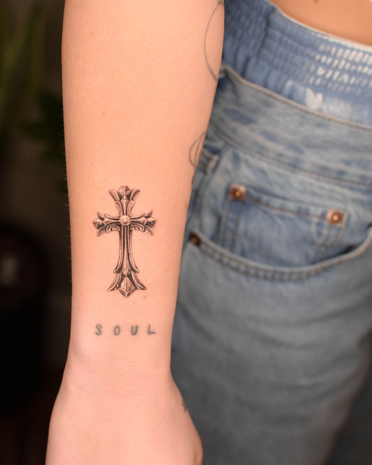 Tattoo — ornate cross, forearm